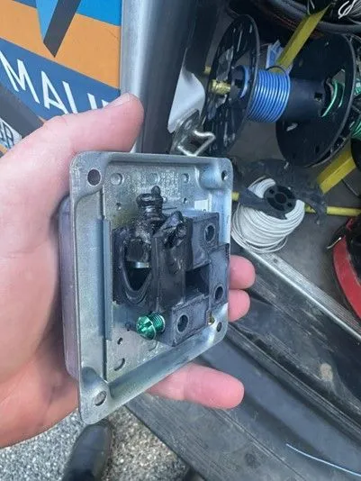 A person is holding a piece of metal in their hand.